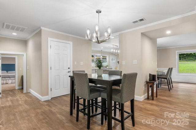 1035 15th Ave NW, Hickory, NC 28601 - dining space with a chandelier, wood finished floors, ornamental molding, baseboards, and recessed lighting