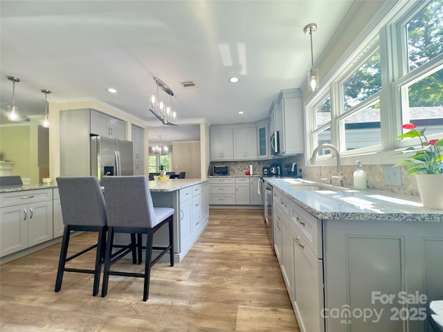 1035 15th Ave NW, Hickory, NC 28601 - kitchen with a sink, stainless steel appliances, plenty of natural light, a center island, and ornamental molding