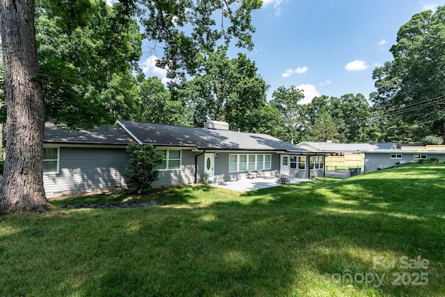 1035 15th Ave NW, Hickory, NC 28601 - rear view of house with a patio, a lawn, and a chimney