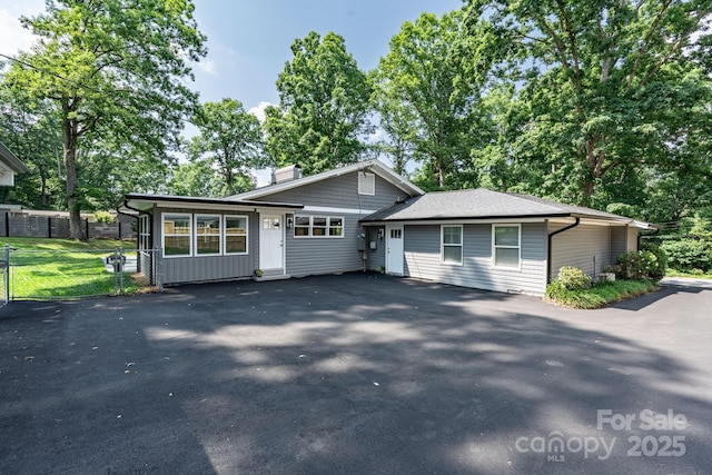 1035 15th Ave NW, Hickory, NC 28601 - tri-level home with a chimney, driveway, and board and batten siding