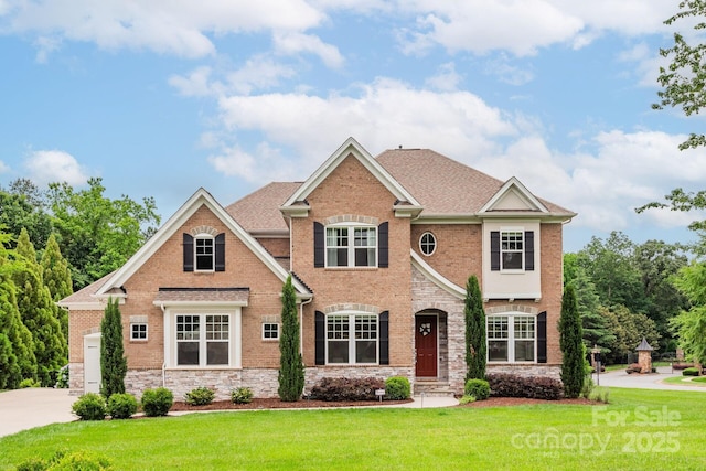 3009 Ocaso Ct, Matthews, NC 28104 - view of front of property with a front yard, brick siding, stone siding, and driveway