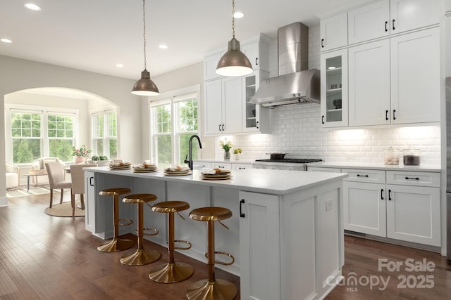 3009 Ocaso Ct, Matthews, NC 28104 - kitchen with wall chimney exhaust hood, decorative backsplash, healthy amount of natural light, dark wood-style floors, and recessed lighting