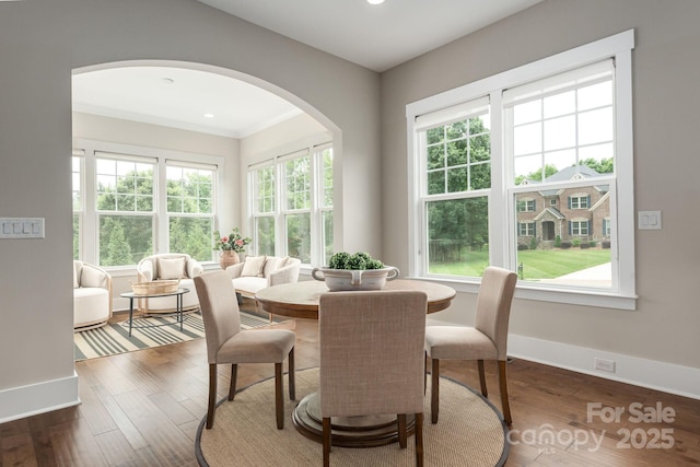 3009 Ocaso Ct, Matthews, NC 28104 - dining space featuring arched walkways, baseboards, recessed lighting, wood finished floors, and ornamental molding