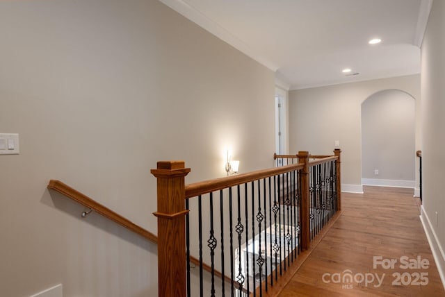3009 Ocaso Ct, Matthews, NC 28104 - hall with an upstairs landing, wood finished floors, recessed lighting, baseboards, and arched walkways
