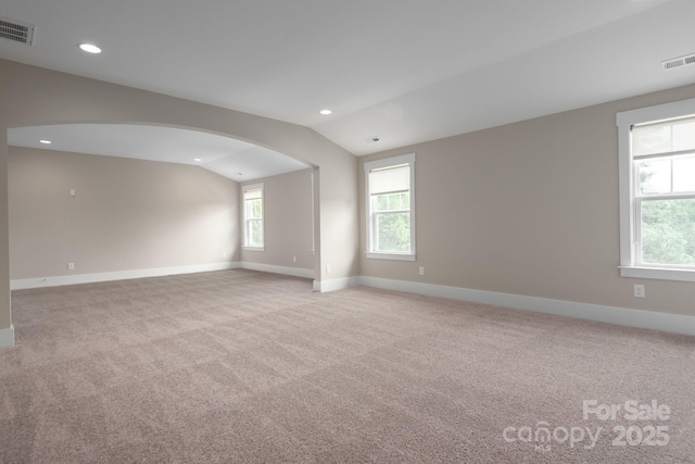 3009 Ocaso Ct, Matthews, NC 28104 - unfurnished room featuring vaulted ceiling, baseboards, carpet floors, arched walkways, and recessed lighting