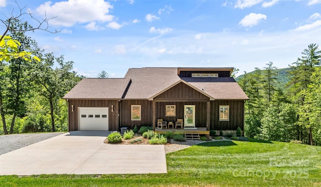 2508 Wolf Pit Rd, Morganton, NC 28655 - view of front of home with covered porch, a garage, concrete driveway, and board and batten siding