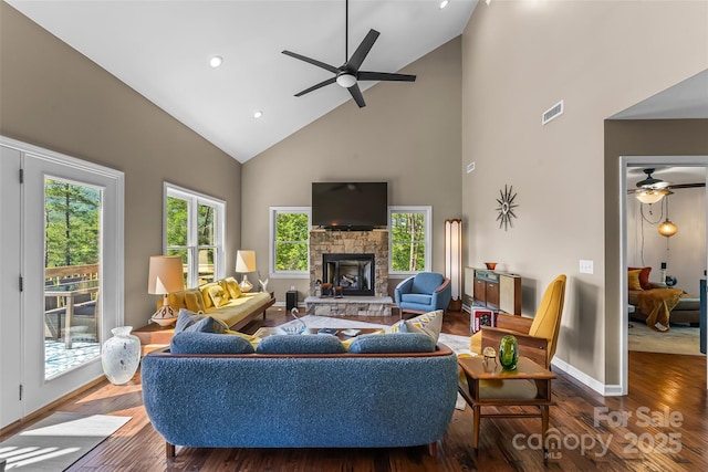 2508 Wolf Pit Rd, Morganton, NC 28655 - living room featuring ceiling fan, high vaulted ceiling, a stone fireplace, wood finished floors, and baseboards