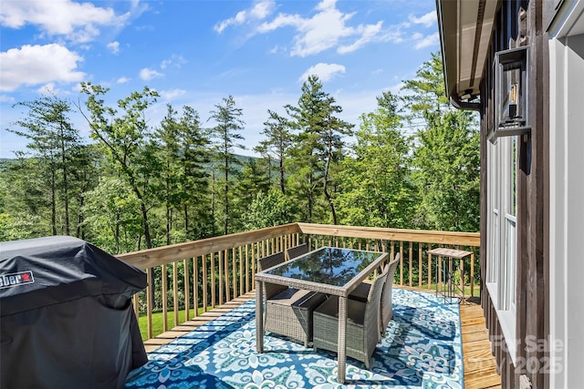 2508 Wolf Pit Rd, Morganton, NC 28655 - deck with a grill, outdoor dining area, and view of scattered trees