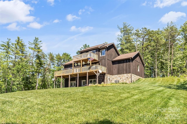 2508 Wolf Pit Rd, Morganton, NC 28655 - rear view of property featuring a deck, a yard, stone siding, and central AC