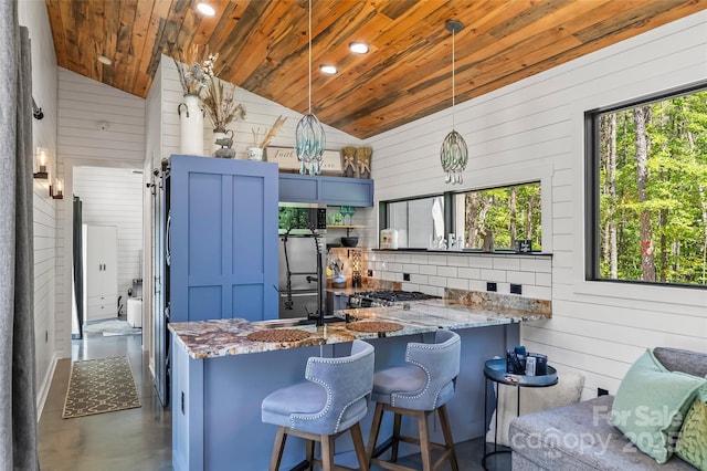 2508 Wolf Pit Rd, Morganton, NC 28655 - kitchen featuring wood ceiling, vaulted ceiling, blue cabinetry, wood walls, and stone counters