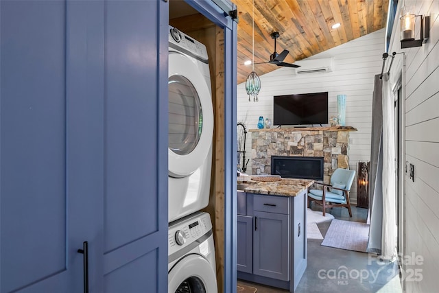 2508 Wolf Pit Rd, Morganton, NC 28655 - laundry area featuring estacked washer and dryer, wooden ceiling, a wall mounted AC, ceiling fan, and wood walls