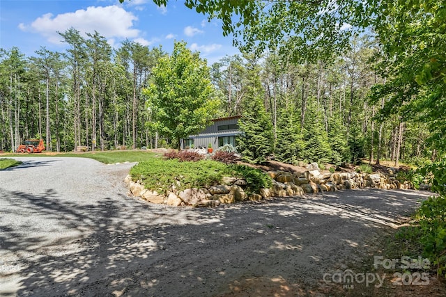 2508 Wolf Pit Rd, Morganton, NC 28655 - view of front facade with board and batten siding and a forest view