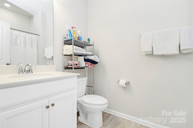 109 Mac Aly, Cramerton, NC 28032 - bathroom with vanity, wood finished floors, toilet, and baseboards