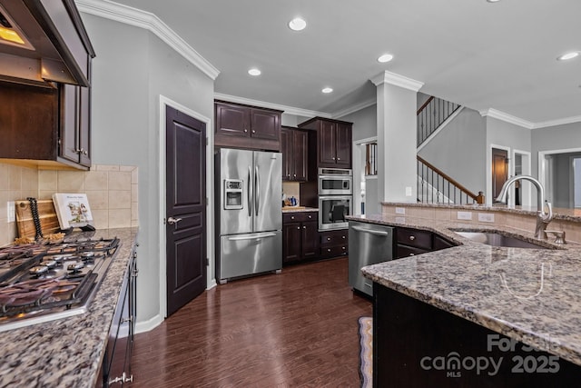 1035 Ivey Ct, Indian Land, SC 29707 - kitchen featuring appliances with stainless steel finishes, a sink, ornamental molding, custom exhaust hood, and light stone counters