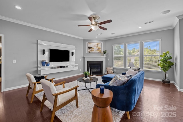 1035 Ivey Ct, Indian Land, SC 29707 - living area featuring a fireplace with flush hearth, a ceiling fan, ornamental molding, dark wood-type flooring, and baseboards