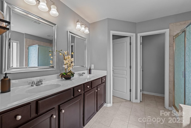 1035 Ivey Ct, Indian Land, SC 29707 - full bathroom featuring a shower stall, double vanity, tile patterned floors, and baseboards