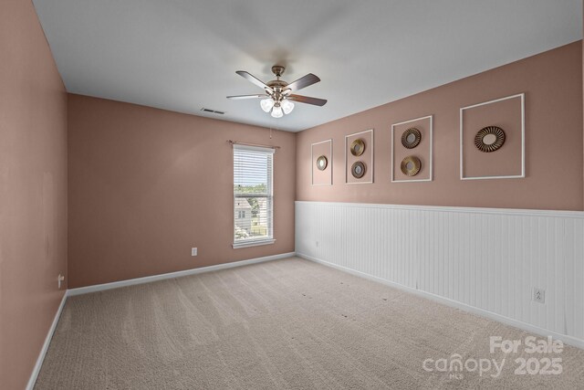 1035 Ivey Ct, Indian Land, SC 29707 - carpeted empty room with a ceiling fan, baseboards, and a wainscoted wall