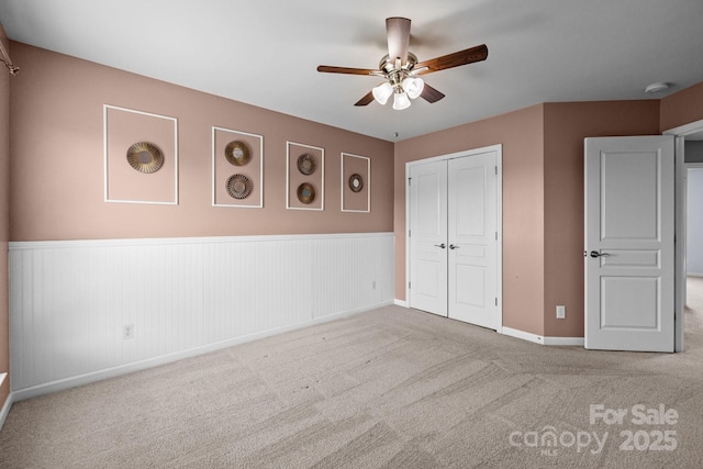 1035 Ivey Ct, Indian Land, SC 29707 - unfurnished bedroom featuring carpet floors, a wainscoted wall, a closet, baseboards, and a ceiling fan