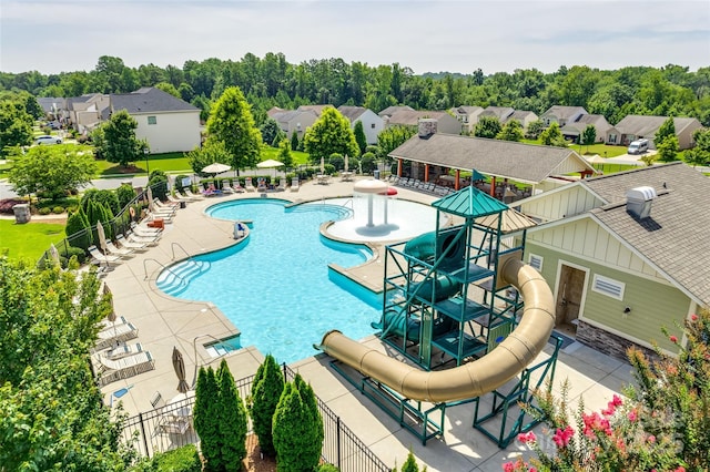 1035 Ivey Ct, Indian Land, SC 29707 - community pool featuring a water slide, a patio area, a residential view, and view of wooded area