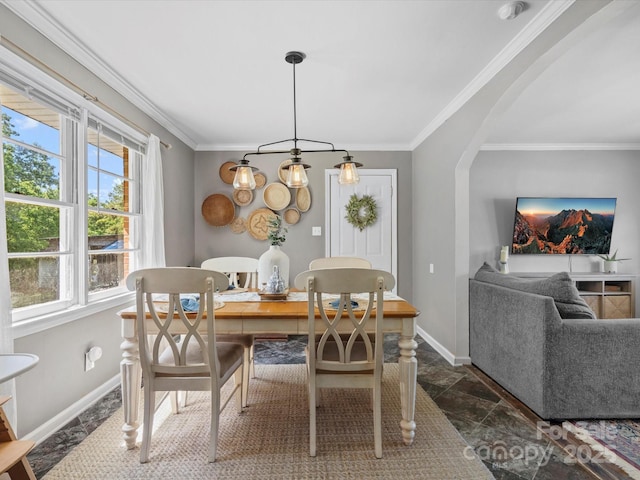 2451 Robert H Kirk Rd, Lancaster, SC 29720 - dining space featuring baseboards, healthy amount of natural light, ornamental molding, dark stone finish floors, and arched walkways