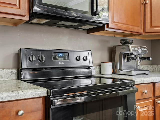 2451 Robert H Kirk Rd, Lancaster, SC 29720 - kitchen featuring stainless steel electric range, brown cabinetry, light countertops, and black microwave