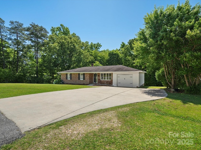 2451 Robert H Kirk Rd, Lancaster, SC 29720 - view of front of house featuring a front yard, a garage, concrete driveway, and brick siding