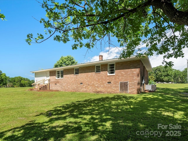 2451 Robert H Kirk Rd, Lancaster, SC 29720 - back of property with crawl space, brick siding, a yard, a chimney, and central AC