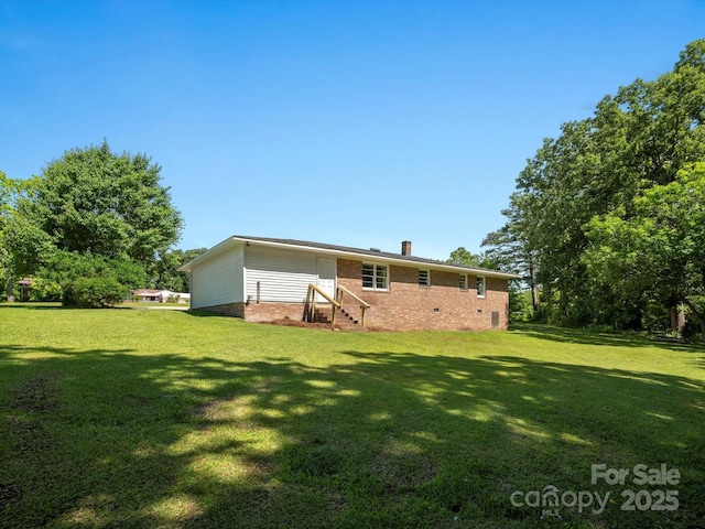 2451 Robert H Kirk Rd, Lancaster, SC 29720 - rear view of house with brick siding, entry steps, a lawn, and a chimney