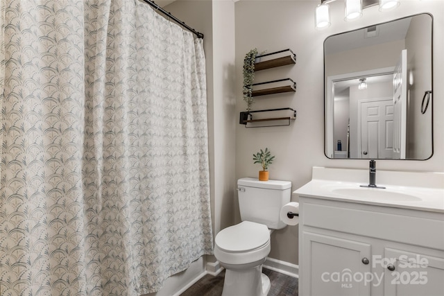9651 Bailey Rd, Cornelius, NC 28031 - full bath with toilet, vanity, baseboards, a shower with shower curtain, and wood finished floors