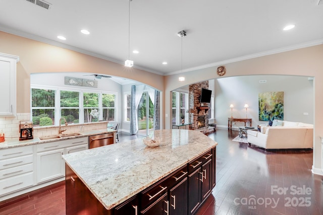 8070 Clems Branch Rd, Indian Land, SC 29707 - kitchen featuring a sink, arched walkways, crown molding, open floor plan, and dishwasher