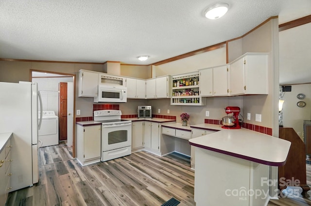 231 Valley View Dr, Clover, SC 29710 - kitchen with white appliances, washer / dryer, a peninsula, a textured ceiling, and open shelves