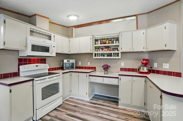 231 Valley View Dr, Clover, SC 29710 - kitchen with white appliances, light wood-style floors, light countertops, a textured ceiling, and tasteful backsplash