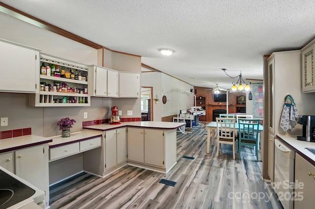 231 Valley View Dr, Clover, SC 29710 - kitchen with a ceiling fan, light wood-style floors, white dishwasher, a textured ceiling, and a peninsula