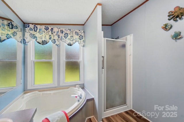 231 Valley View Dr, Clover, SC 29710 - bathroom featuring a stall shower, ornamental molding, a bath, wood finished floors, and a textured ceiling