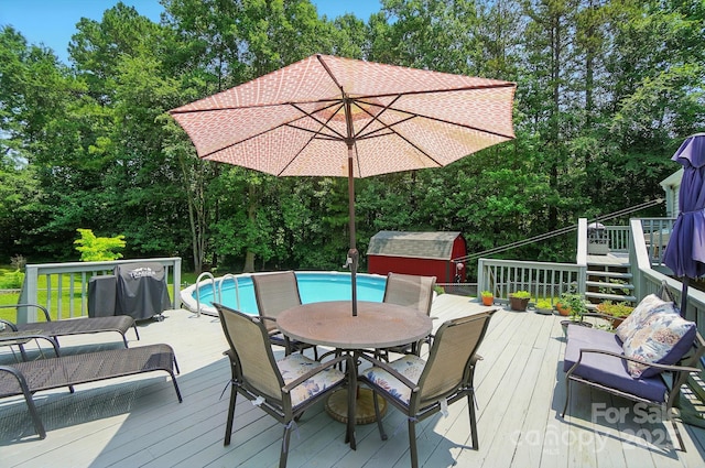 231 Valley View Dr, Clover, SC 29710 - deck with outdoor dining area, view of wooded area, and an outdoor pool