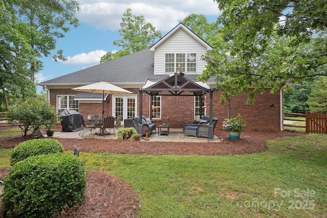 105 Prairie Rose Ct, Waxhaw, NC 28173 - rear view of house featuring a patio area, brick siding, a shingled roof, and an outdoor hangout area