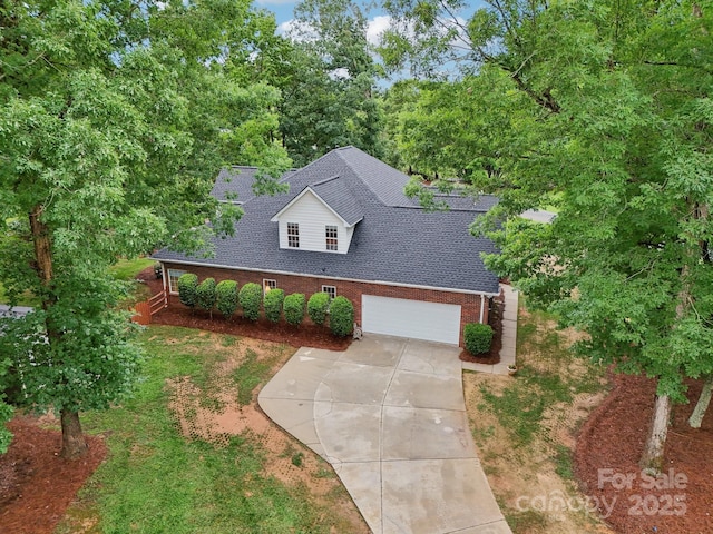 105 Prairie Rose Ct, Waxhaw, NC 28173 - view of front of property featuring brick siding, roof with shingles, concrete driveway, an attached garage, and a front lawn