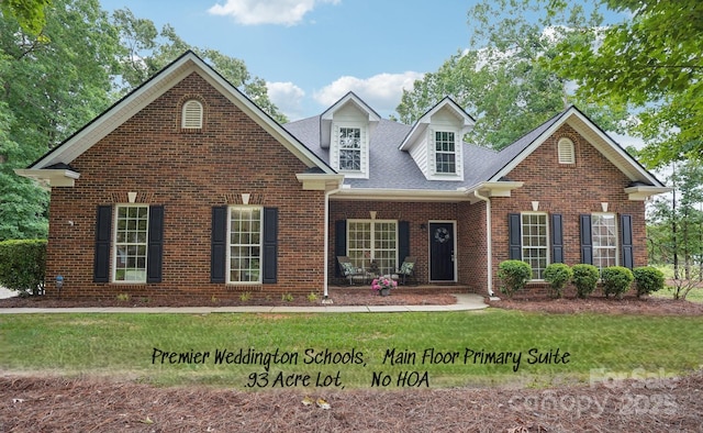 105 Prairie Rose Ct, Waxhaw, NC 28173 - view of front of house with brick siding, a front yard, and roof with shingles