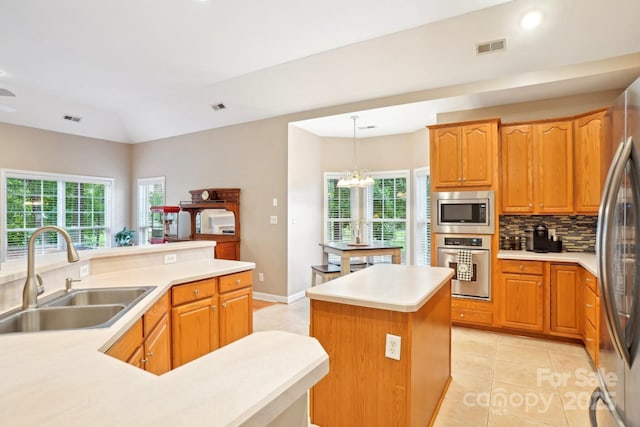 105 Prairie Rose Ct, Waxhaw, NC 28173 - kitchen featuring stainless steel appliances, a sink, light tile patterned flooring, plenty of natural light, and vaulted ceiling