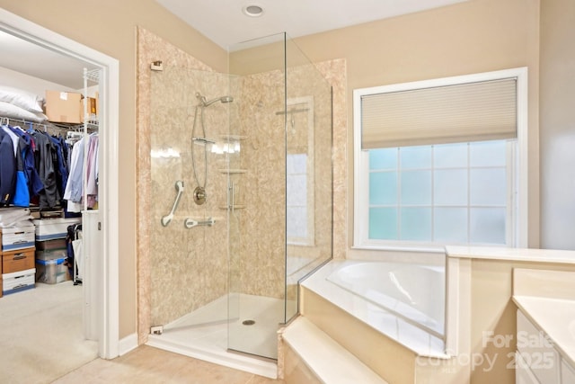 105 Prairie Rose Ct, Waxhaw, NC 28173 - bathroom with a stall shower, a bath, vanity, a walk in closet, and tile patterned floors