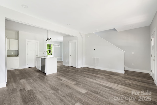 156 Mingus Hill Rd, Canton, NC 28716 - unfurnished living room with a sink, dark wood-style floors, and baseboards