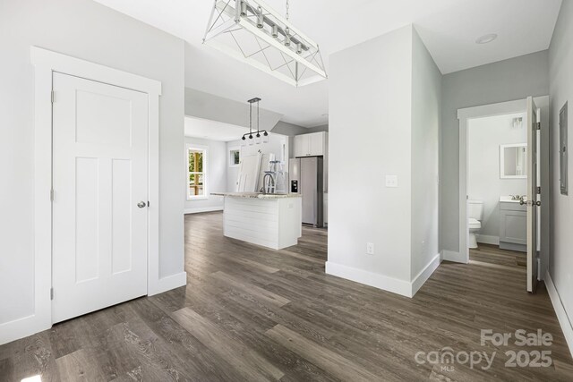 156 Mingus Hill Rd, Canton, NC 28716 - unfurnished living room featuring baseboards, dark wood-style floors, and a sink