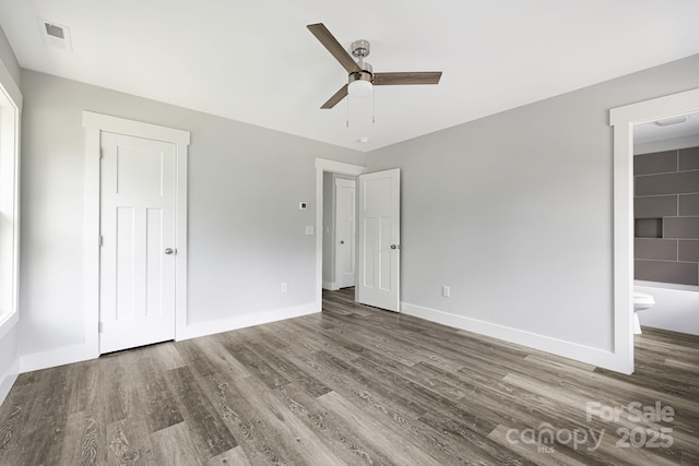 156 Mingus Hill Rd, Canton, NC 28716 - unfurnished bedroom featuring wood finished floors, baseboards, ceiling fan, and connected bathroom