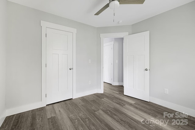 156 Mingus Hill Rd, Canton, NC 28716 - unfurnished bedroom featuring dark wood finished floors, baseboards, and a ceiling fan