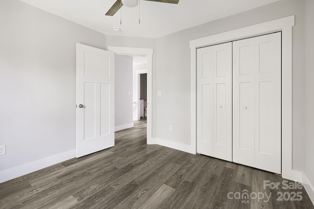 156 Mingus Hill Rd, Canton, NC 28716 - unfurnished bedroom with dark wood-type flooring, baseboards, a closet, and ceiling fan