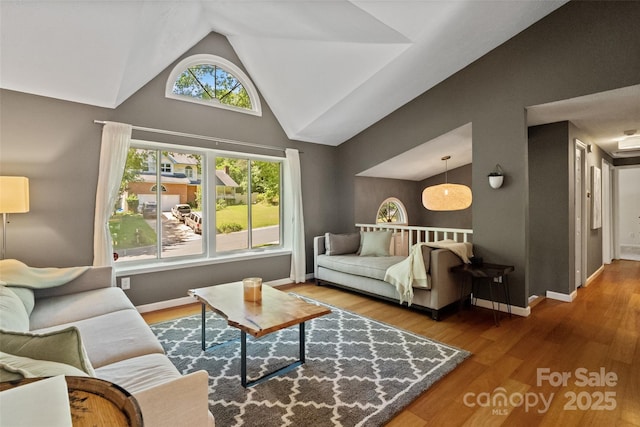 7018 Rollingridge Dr, Charlotte, NC 28211 - living room featuring wood finished floors, baseboards, and high vaulted ceiling