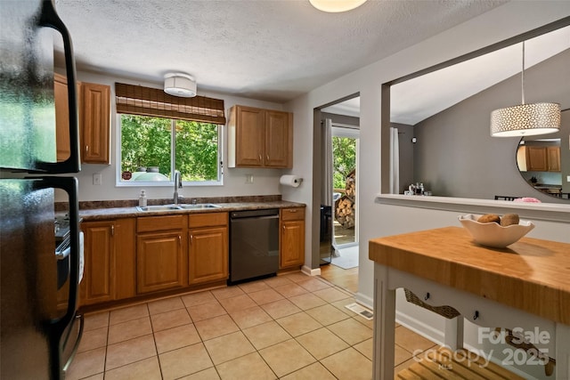 7018 Rollingridge Dr, Charlotte, NC 28211 - kitchen with dishwashing machine, a sink, healthy amount of natural light, freestanding refrigerator, and a textured ceiling