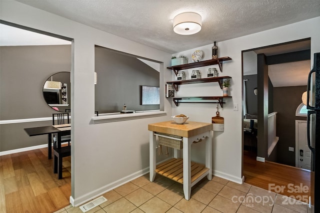7018 Rollingridge Dr, Charlotte, NC 28211 - hall with a textured ceiling, light tile patterned floors, and baseboards