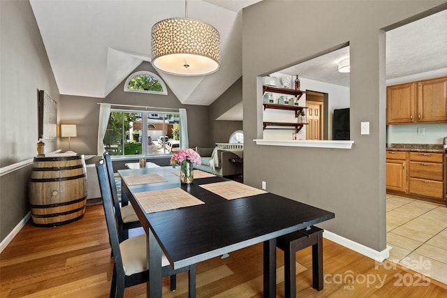 7018 Rollingridge Dr, Charlotte, NC 28211 - dining room featuring light wood finished floors, baseboards, and lofted ceiling