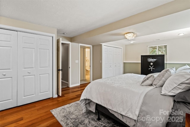 7018 Rollingridge Dr, Charlotte, NC 28211 - bedroom featuring multiple closets, wood finished floors, and baseboards